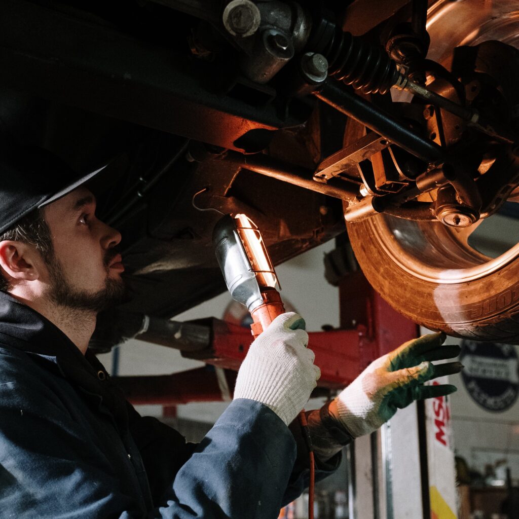 Man in Blue Dress Shirt Holding Brown Wooden Tool